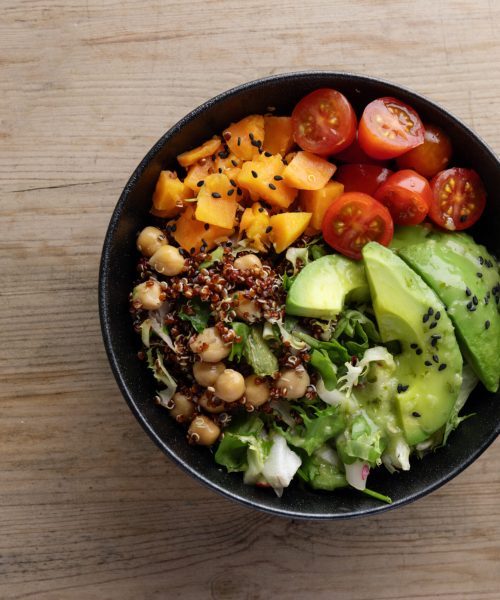 Fresh tasty healthy poke bowl on wooden asesoria plant based